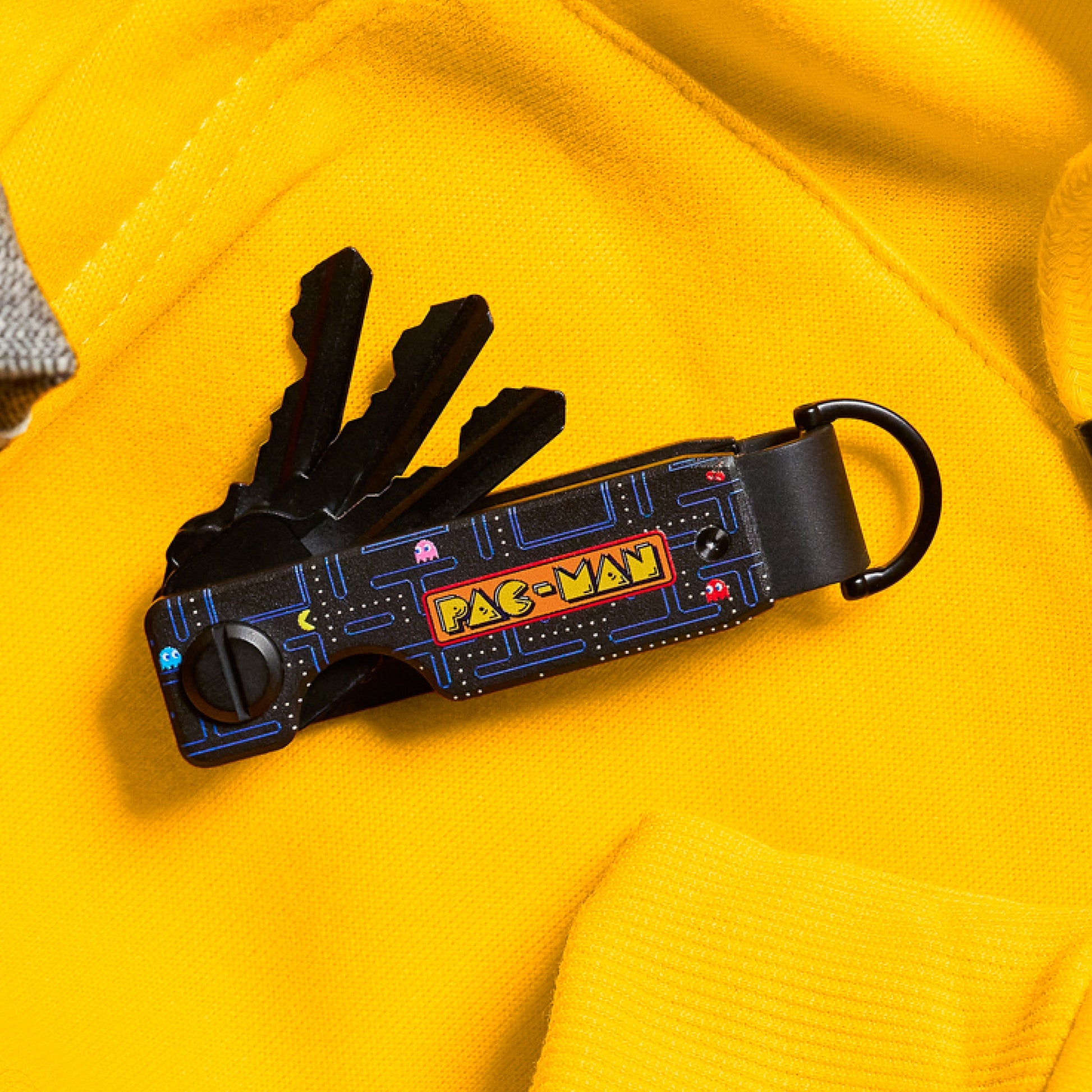 https://cdn.shopify.com/s/files/1/0613/6213/files/PacMan-Keycase-Lifestyle1_b449a292-ebec-4a7c-9db5-2009f8311753.jpg?v=1756931371